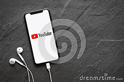 Riga, Latvia - March 25, 2018: Latest generation iPhone X with YouTube logo on the screen. Editorial Stock Photo