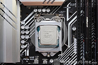 Latest Intel processor chip in socket on Asus motherboard, close-up in flat lay Editorial Stock Photo