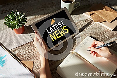 Latest news text and icon on device screen. Business internet and technology concept. Stock Photo