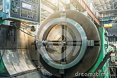 Lathe automated machine in factory workshop, boring of part with milling tool. Metalworking machine grinds tube metal Stock Photo