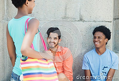 Latin and african american young adult speaking with girl Stock Photo