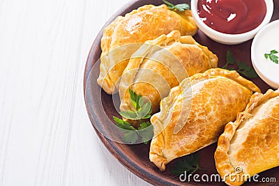 Latin American baked beef empanadas with sauce Stock Photo