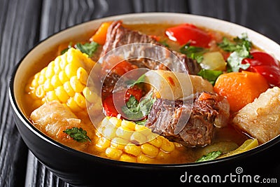 Latin American Sancocho thick meat soup with vegetables close-up on a plate on the table. horizontal Stock Photo