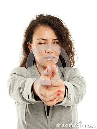 Latin businesswoman taking aim and shooting Stock Photo