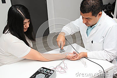 Latin doctor specialist neurologist performs a study of evoked potentials, diagnostic techniques with sensory stimuli and the reco Stock Photo