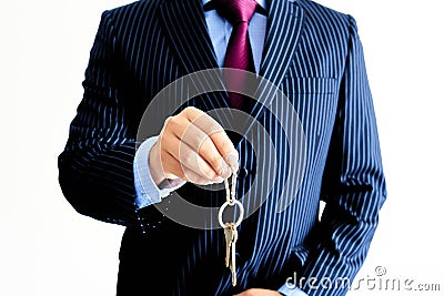 Latin man in suit handing over house keys, blue jacket, icing tie, blue shirt Stock Photo