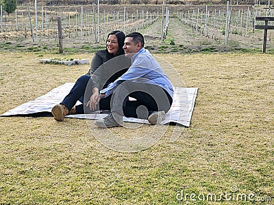 Latin man and woman couple in their 40s without children spends a day of rest having a picnic in a vineyard enjoying quality time Stock Photo