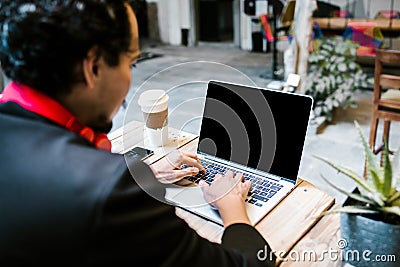 Latin man working with computer at office in Mexico city Stock Photo