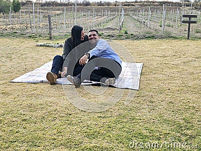 Latin man and woman couple in their 40s without children spends a day of rest having a picnic in a vineyard enjoying quality time Stock Photo