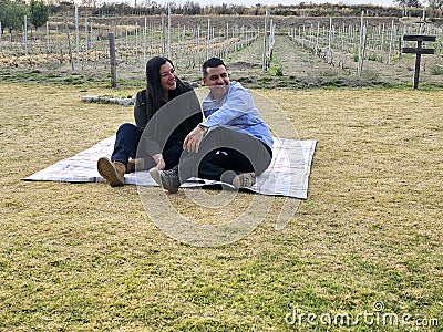 Latin man and woman couple in their 40s without children spends a day of rest having a picnic in a vineyard enjoying quality time Stock Photo