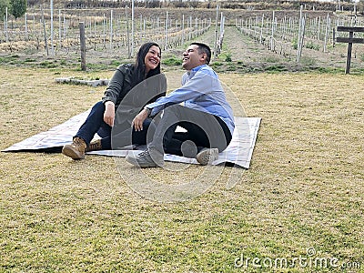 Latin man and woman couple in their 40s without children spends a day of rest having a picnic in a vineyard enjoying quality time Stock Photo