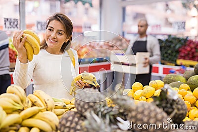 Latin woman in produce section of supermarket Stock Photo