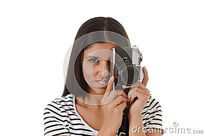 Latin woman taking pictures looking through the viewfinder of an old cool retro vintage photo camera Stock Photo