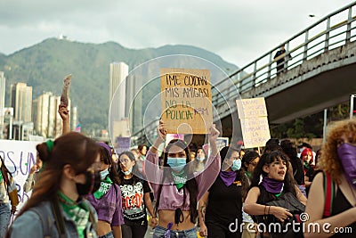 Latina woman during a march holds a banner that reads in spanish Editorial Stock Photo