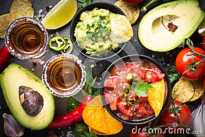 Latinamerican food party sauce guacamole, salsa, chips and tequi Stock Photo