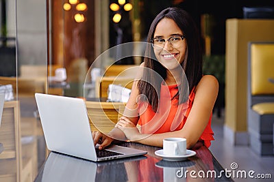 Latinamerican girl have a coffee break in a cafe Stock Photo