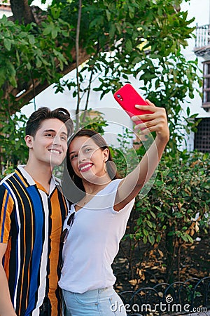 Latino couple taking selfie in the park Stock Photo