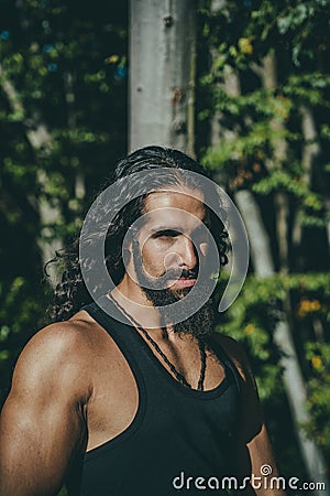 Latino male. Young handsome man with long hair beard, mustache and trendy hairdo. Stock Photo