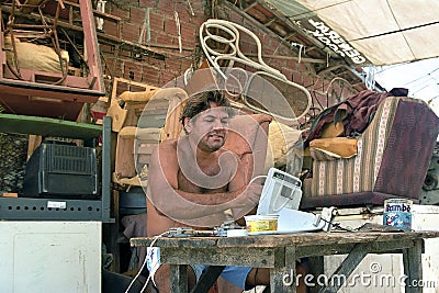 Latino repairer works in his repair shop, Brazil Editorial Stock Photo