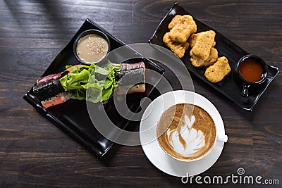 Latte art coffee cup with roll salad and chicken nugget Stock Photo