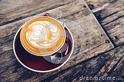 Close up of hot latte coffee serving on the wooden table. Stock Photo