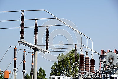 Lattice-type steel tower fragment over blue sky as a part of high-voltage line. Overhead power line details Stock Photo