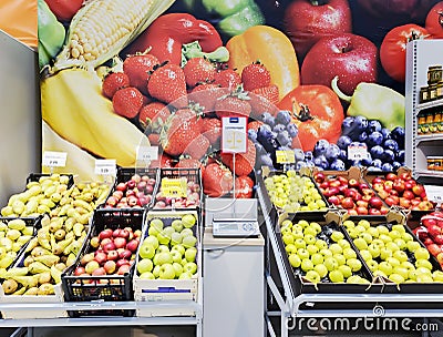 Fresh fruit section for sale at a vegetable with control weights in the center of a supermarket. Editorial Stock Photo