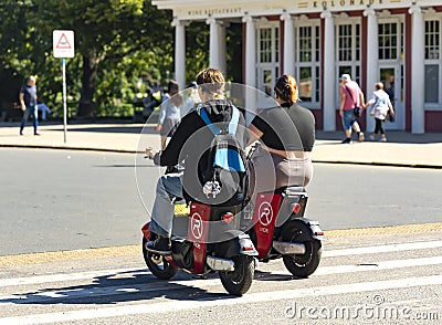 Movement of tourists on city electric bike in Riga Old Town, Latvia. Editorial Stock Photo