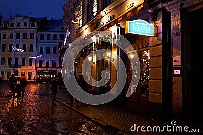 Latvia. Festive festivities of people on the night streets of Riga. Christmas in Riga. January 01, 2018 Editorial Stock Photo