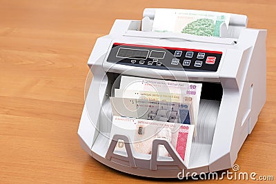 Latvian Lats in a counting machine Stock Photo