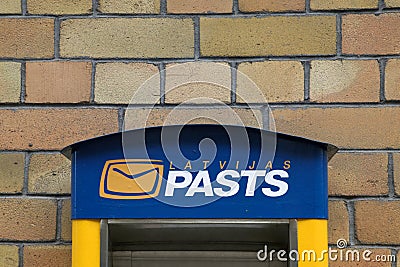 Latvijas pasts or in English Latvian Post mail box on brick wall background Editorial Stock Photo