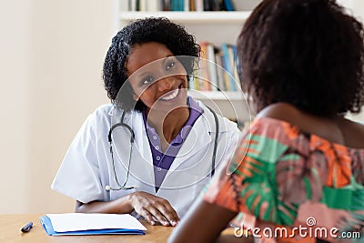 Laughing african american female doctor with patient Stock Photo