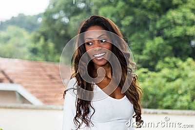 Laughing african american woman with long hair Stock Photo