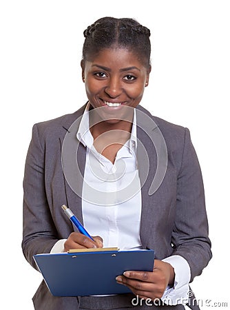 Laughing African business woman with clipboard Stock Photo