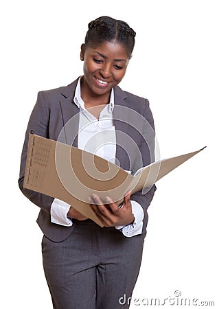 Laughing african business woman reading file Stock Photo