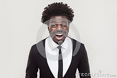 Laughing afro businessman looking at camera and toothy smiling. Stock Photo