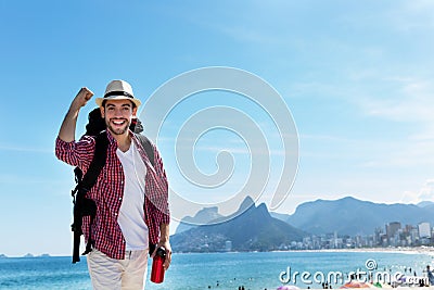 Laughing american hipster tourist at Ipanema beach at Rio de Janeiro Stock Photo