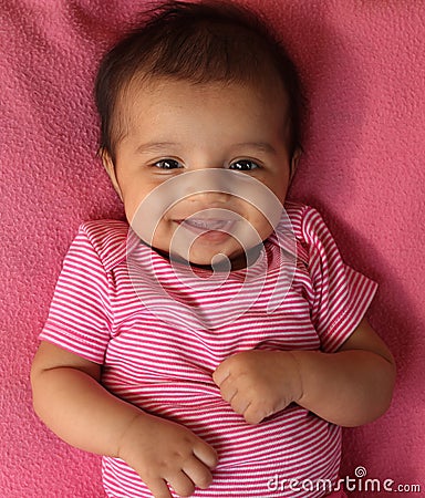 Laughing asian baby girl in pink cloths Stock Photo