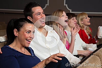 Laughing audience at the movies Stock Photo