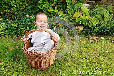 Laughing baby boy in wicked basket Stock Photo