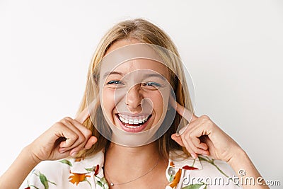 Laughing beautiful girl plugging her ears while posing at camera Stock Photo