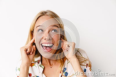 Laughing beautiful girl plugging her ears while posing at camera Stock Photo