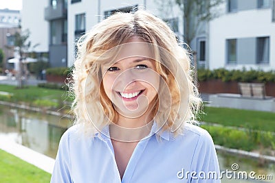 Laughing blond woman in a residential area Stock Photo