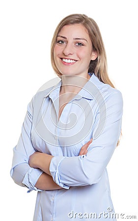 Laughing blonde german woman in blue blouse with crossed arms Stock Photo