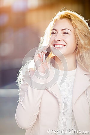 Laughing blonde talking on phone Stock Photo