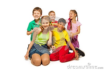 Laughing children sitting on the floor together Stock Photo
