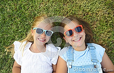 Laughing children wearing sunglasses relaxing during summer day Stock Photo