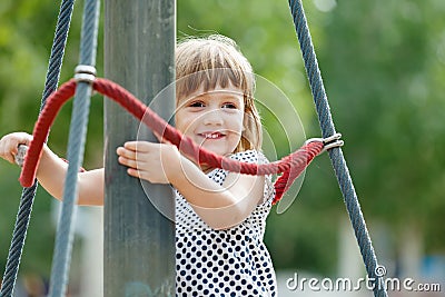 Laughing girl climbing at playground Stock Photo