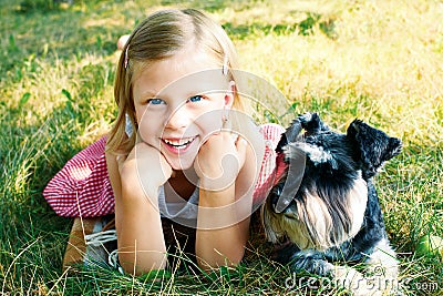 Laughing girl and her trusty miniature schnauzer Stock Photo