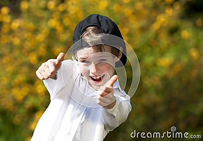 Laughing handsome boy posing both thumbs up Stock Photo